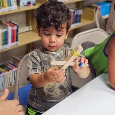 Children making crafts during a library activity